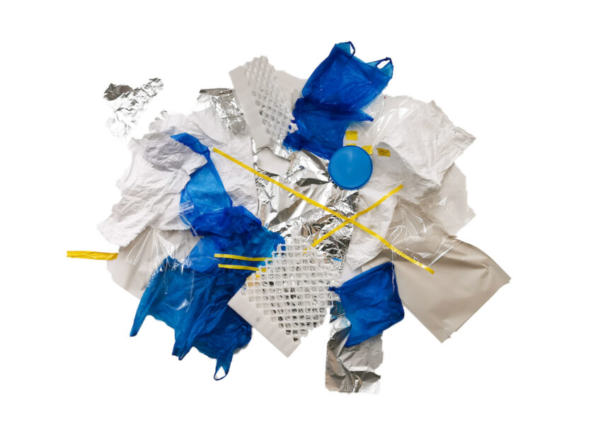 Glacier by Celestine Thomas, Tin foil, plastic bag, tape, paper, cellophane, styrofoam and plastic sweet lid on studio wall.