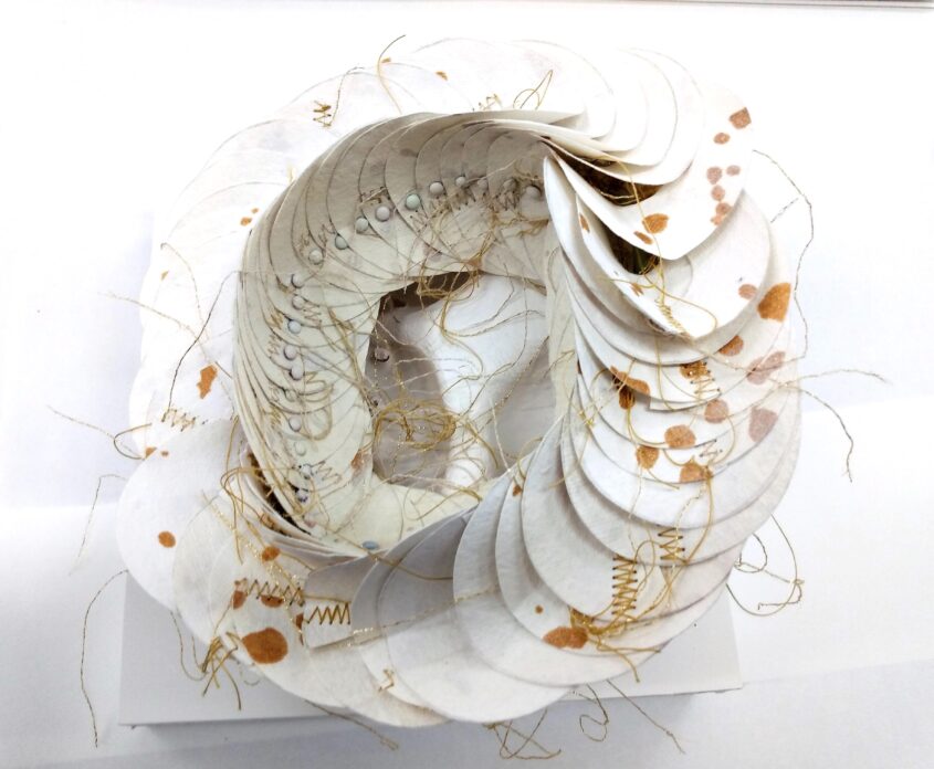Crown by Melissa Harris, cotton rag paper, silk thread, fasteners, paperclay